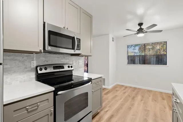 a kitchen with stainless steel appliances a stove microwave and cabinets