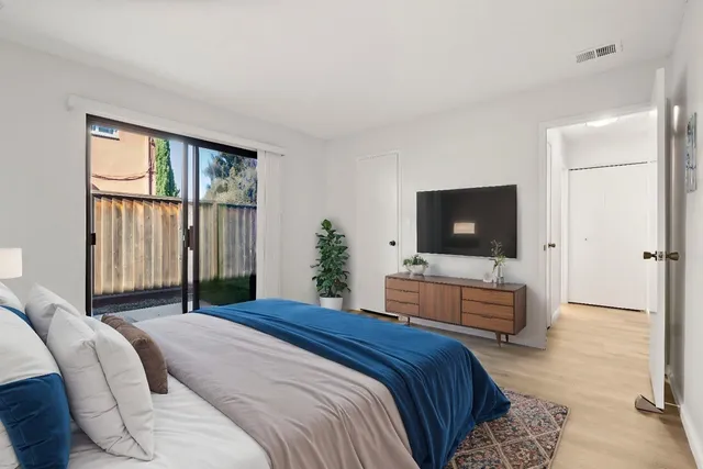 a bedroom with a bed and a flat screen tv