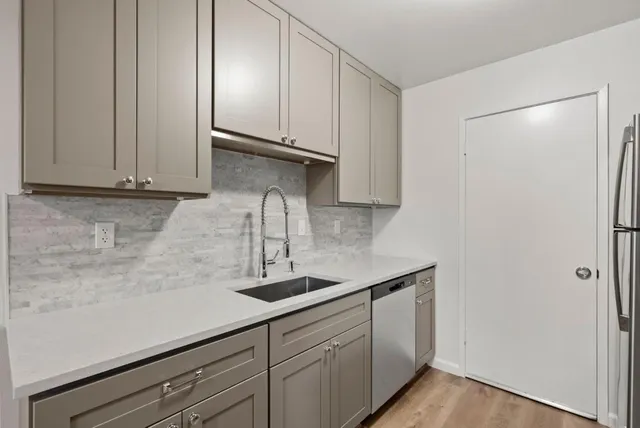a kitchen with a sink and cabinets