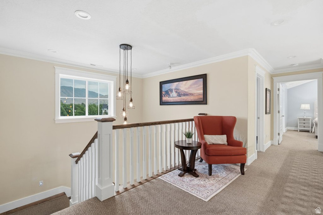 672 Perry Hollow Drive Mapleton, UT 84664 - Photo 41 of 106 Upper-level landing featuring a multi-pane window, modern multi-pendant light fixture, recessed ceiling lighting, crown molding, and carpeted flooring