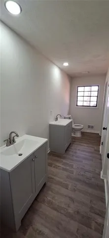 a room with a sink window and mirror
