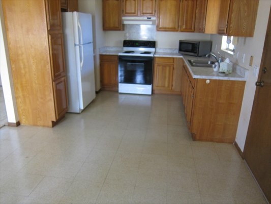 8562 Kekaha Road Kekaha, HI 96752 - Photo 7 of 12 a kitchen with a stove and a refrigerator