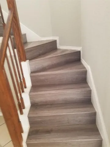 a bathroom with a granite countertop bathtub sink vanity and toilet