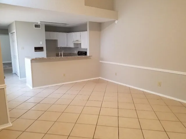 a view of a kitchen with white cabinets