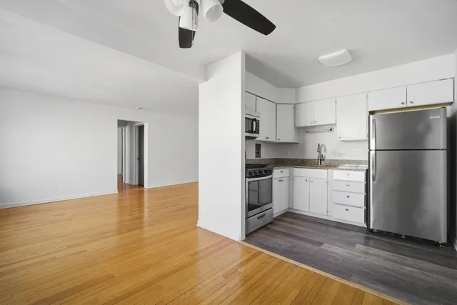 a kitchen with white cabinets and stainless steel appliances