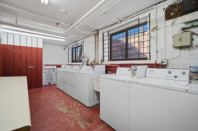 a utility room with cabinets washer and dryer