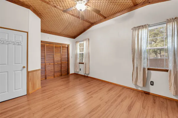 a view of empty room with wooden floor