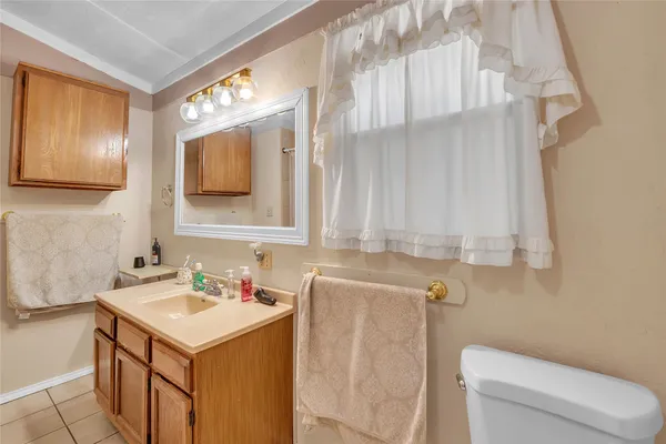 a bathroom with a sink a toilet and mirror