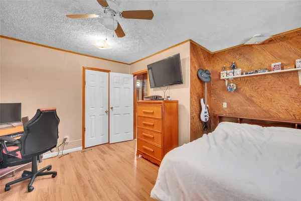 a bedroom with a bed and a television