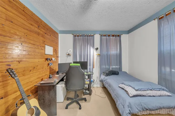 a bedroom with a bed and chair