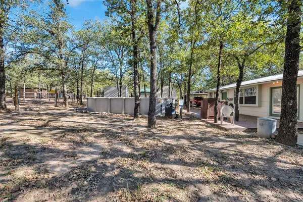 a view of a backyard with large trees
