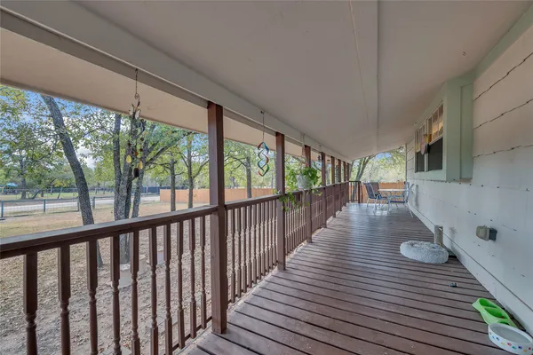 a view of a balcony with wooden floor