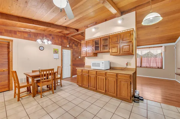 a kitchen with stainless steel appliances kitchen island granite countertop furniture a dining table and chair