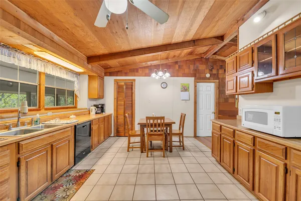 a kitchen with stainless steel appliances a sink stove and cabinets
