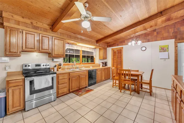 a kitchen with table chairs and white appliances