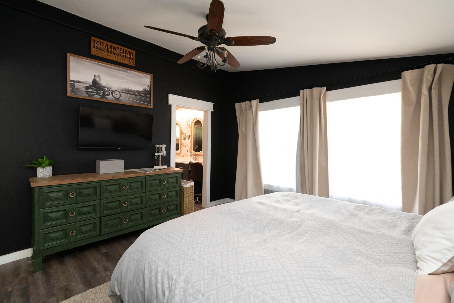 16990 Covina Road Bend, OR 97707 - Photo 27 of 56 a bedroom with a large bed and a flat tv screen
