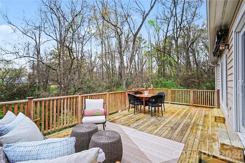 a view of a chairs and table on the roof deck