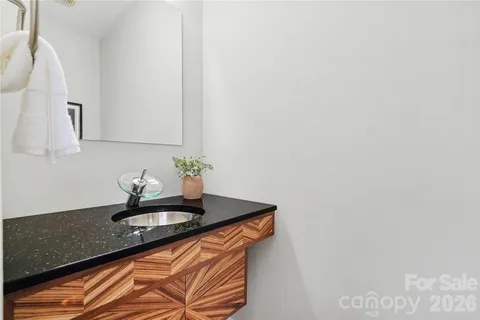 a vase of flowers sitting on a granite counter top