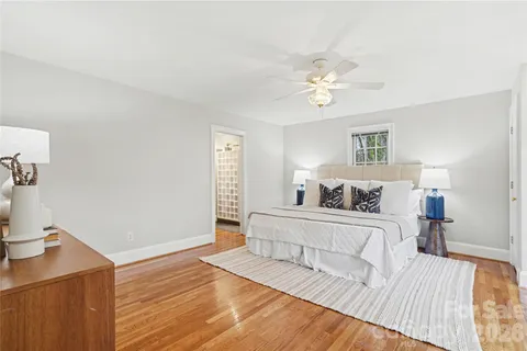a spacious bedroom with a bed and a chandelier