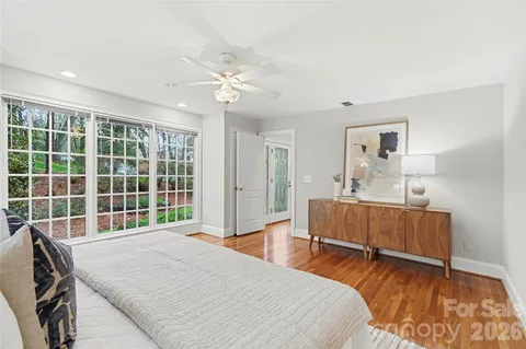 a bedroom with a bed and a dresser next to a window