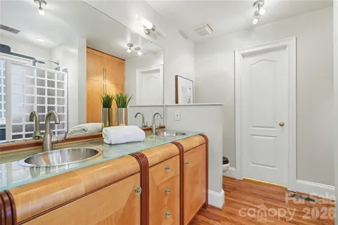 a view of empty room with wooden floor and windows