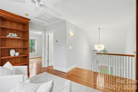 a living room with furniture and a book shelf