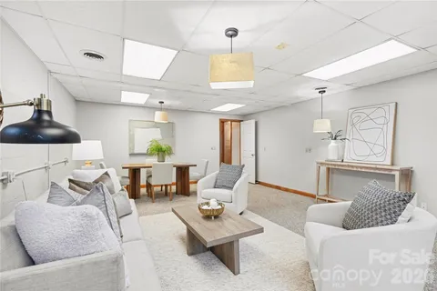 a very nice looking dining room with a large window table and chairs