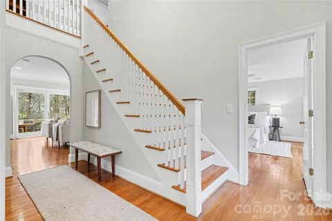 a view of entryway and hall with wooden floor