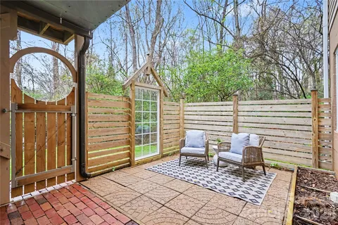 a backyard of a house with yard and outdoor seating