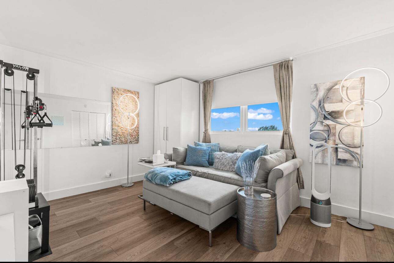 5500 Northwest 2nd Avenue, Unit 414 Boca Raton, FL 33487 - Photo 15 of 38 a living room with furniture a large window and a wooden floor