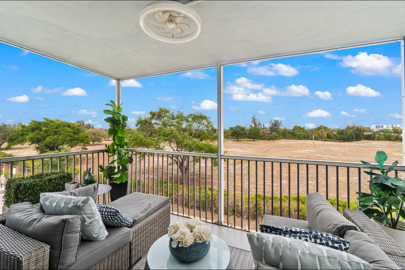 5500 Northwest 2nd Avenue, Unit 414 Boca Raton, FL 33487 - Photo 24 of 38 a balcony with furniture and a garden