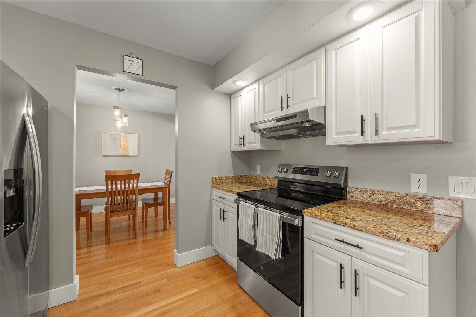 2608 Rachel Road Champaign, IL 61822 - Photo 12 of 47 a kitchen with stainless steel appliances granite countertop a stove a sink and a refrigerator