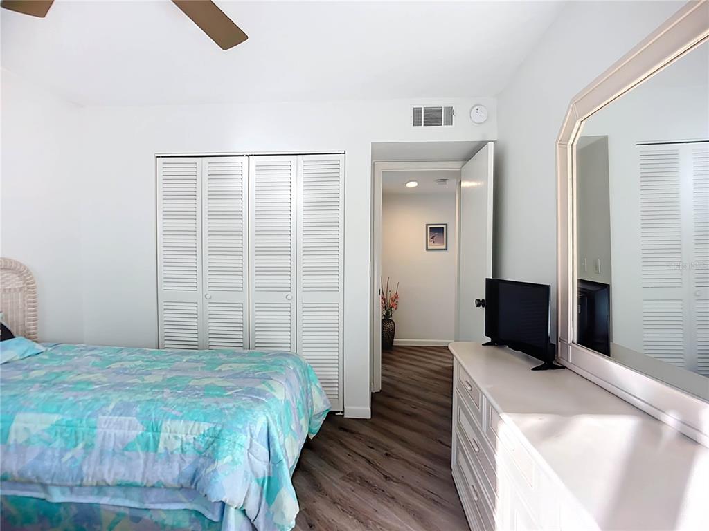 1508 Pelican Cove Road, Unit GR232 Sarasota, FL 34231 - Photo 12 of 54 a bedroom with a bed and wooden floor