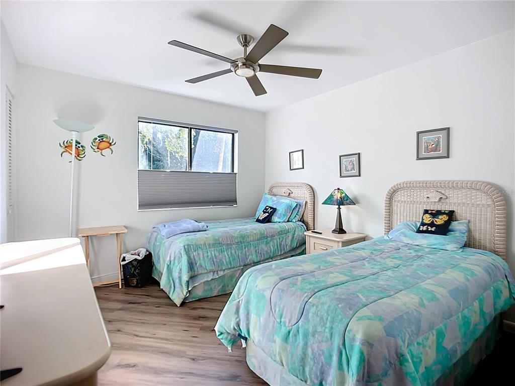 1508 Pelican Cove Road, Unit GR232 Sarasota, FL 34231 - Photo 13 of 54 a bedroom with two beds and a window