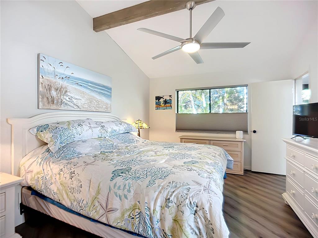 1508 Pelican Cove Road, Unit GR232 Sarasota, FL 34231 - Photo 15 of 54 a bedroom with a bed and a flat screen tv