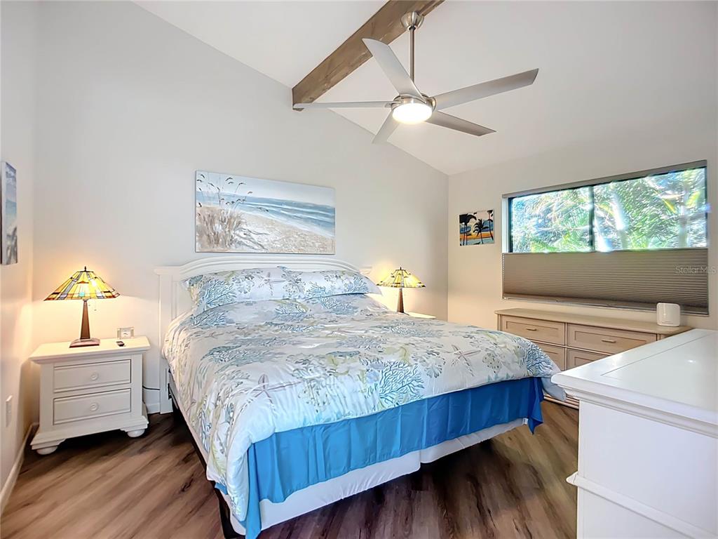 1508 Pelican Cove Road, Unit GR232 Sarasota, FL 34231 - Photo 16 of 54 a bedroom with a bed and a chandelier