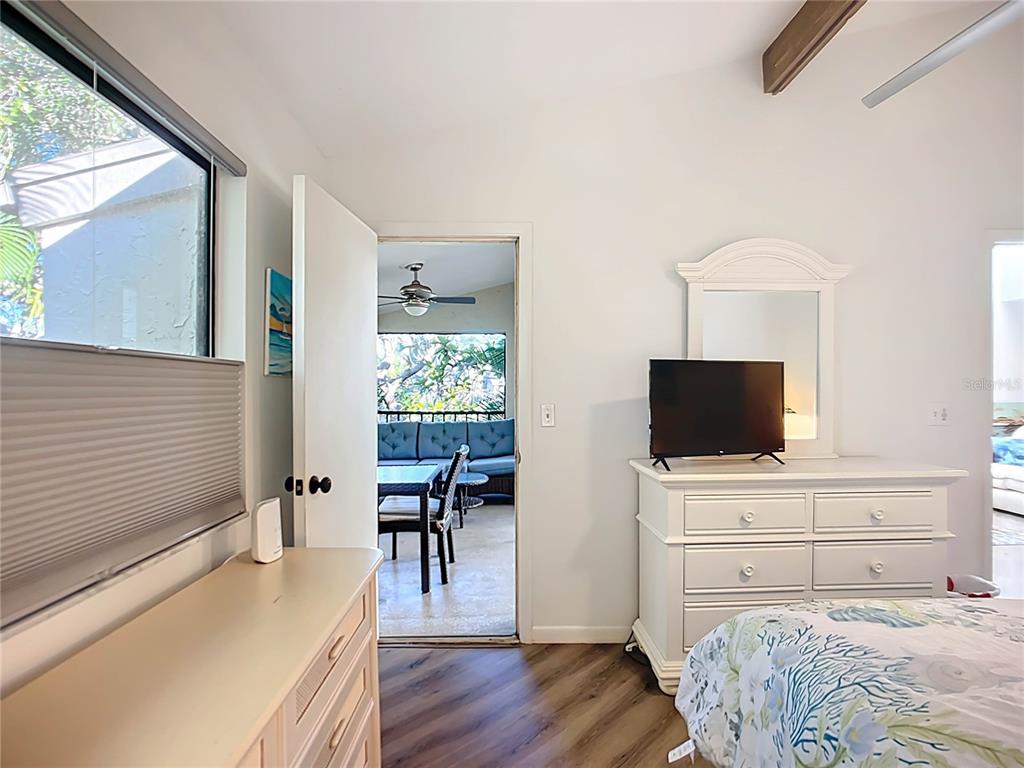 1508 Pelican Cove Road, Unit GR232 Sarasota, FL 34231 - Photo 18 of 54 a bedroom with a bed and a flat screen tv