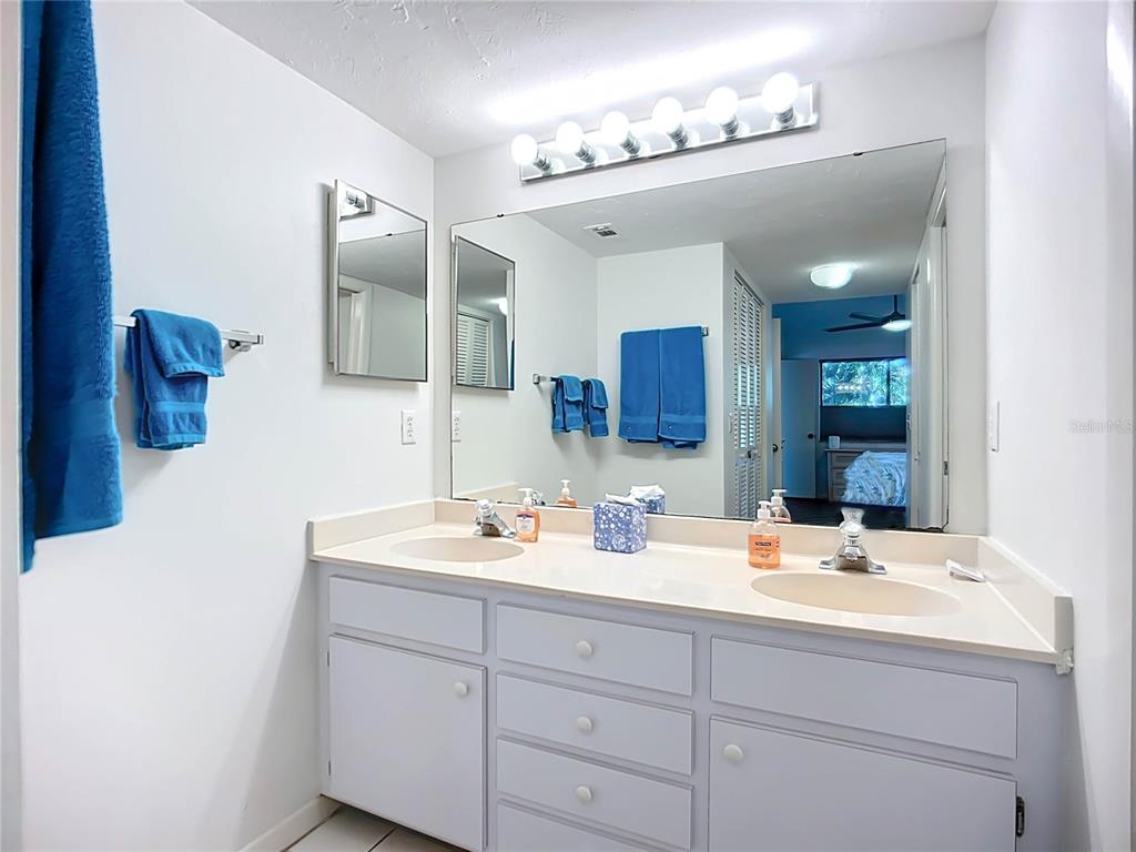 1508 Pelican Cove Road, Unit GR232 Sarasota, FL 34231 - Photo 21 of 54 a bathroom with a sink vanity and mirror