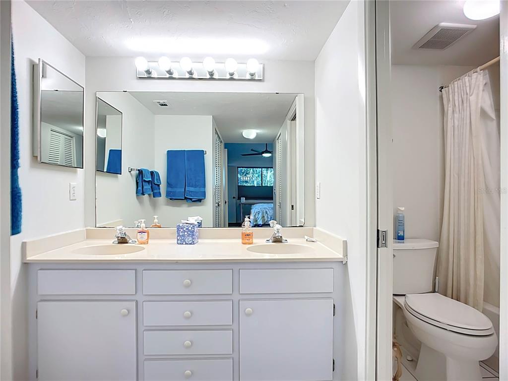 1508 Pelican Cove Road, Unit GR232 Sarasota, FL 34231 - Photo 22 of 54 a bathroom with a sink a toilet and a mirror