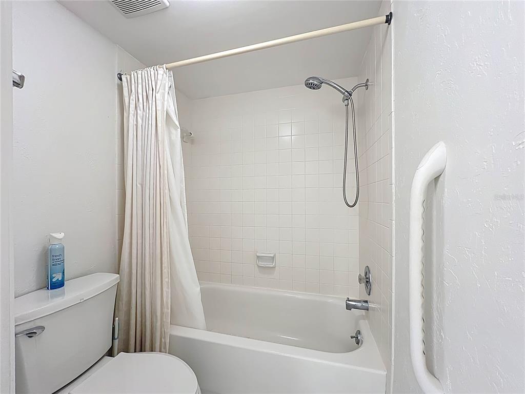 1508 Pelican Cove Road, Unit GR232 Sarasota, FL 34231 - Photo 23 of 54 a bathroom with a shower curtain and a toilet