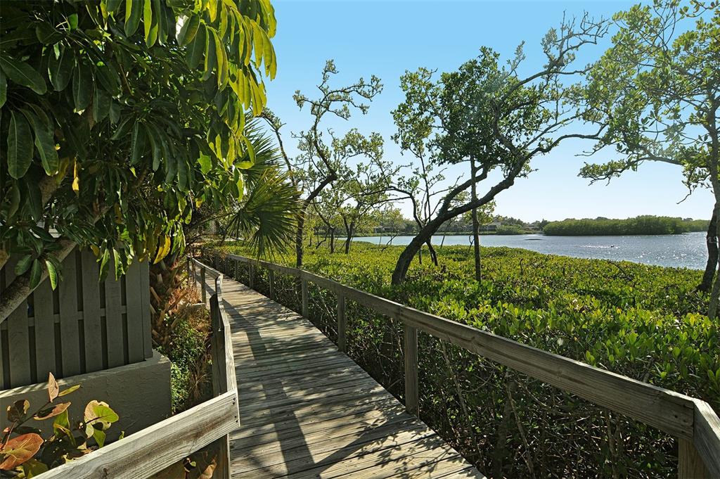 1508 Pelican Cove Road, Unit GR232 Sarasota, FL 34231 - Photo 39 of 54 a view of balcony with wooden floor and fence