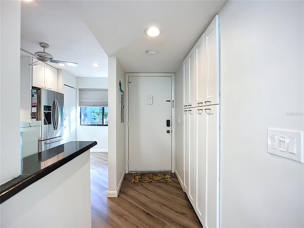 1508 Pelican Cove Road, Unit GR232 Sarasota, FL 34231 - Photo 6 of 54 a view of a hallway with a livingroom and fireplace