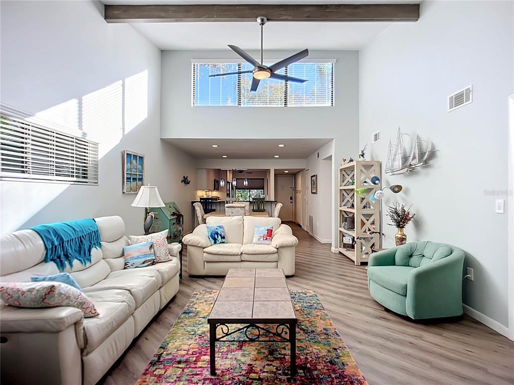 1508 Pelican Cove Road, Unit GR232 Sarasota, FL 34231 - Photo 10 of 54 a living room with furniture and a wooden floor