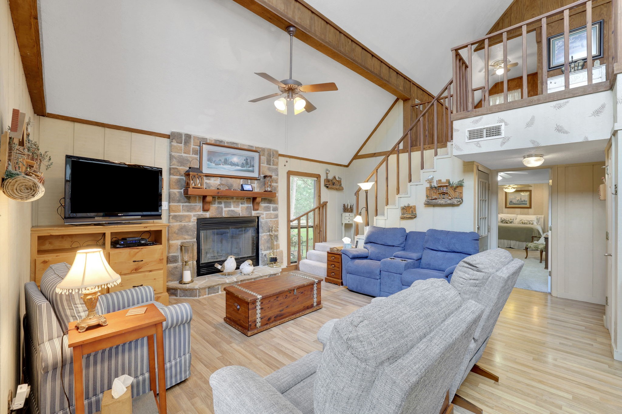 780 Hickory Ridge Drive Coldspring, TX 77331 - Photo 11 of 40 The living area features a wood burning fireplace and cathedral ceilings with wood beam accents