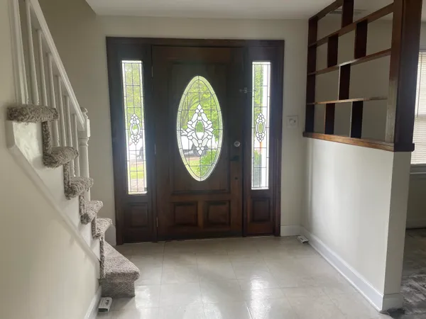 a living room with a furniture and a large window