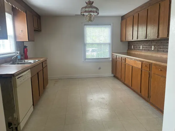 a kitchen with sink cabinets and window