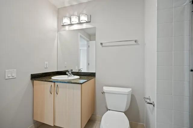 a bathroom with a toilet a sink and mirror