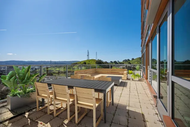 a view of a chairs and table in the balcony