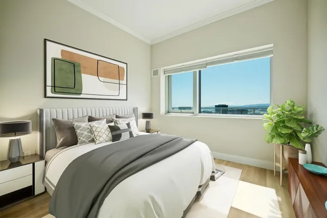 a bedroom with bed and a potted plant