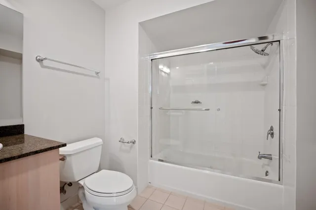 a bathroom with a shower a toilet and a shower